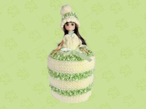 Brunette doll wearing a pale yellow and lime knitted toilet roll dress.