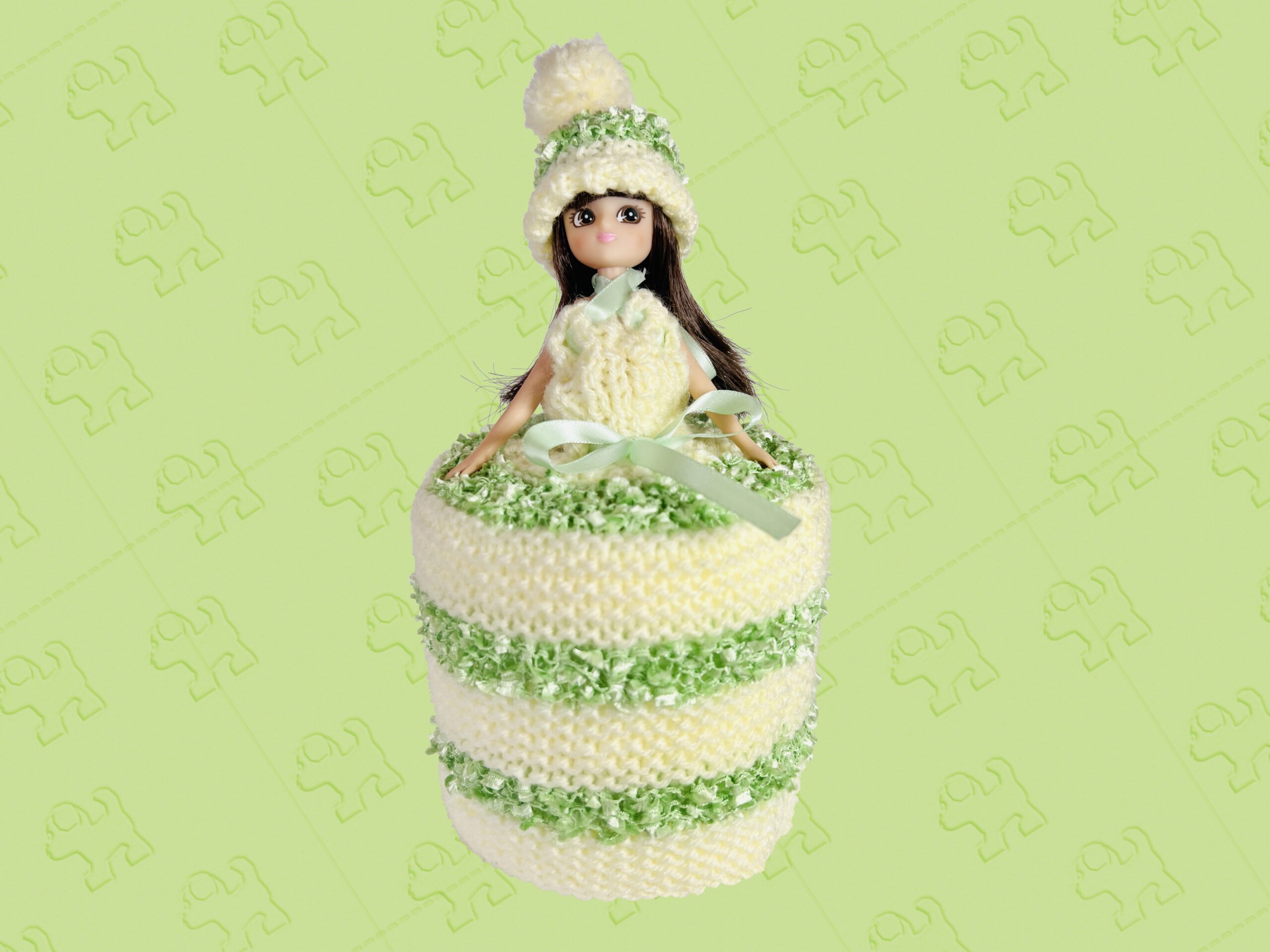 Brunette doll wearing a pale yellow and lime knitted toilet roll dress.