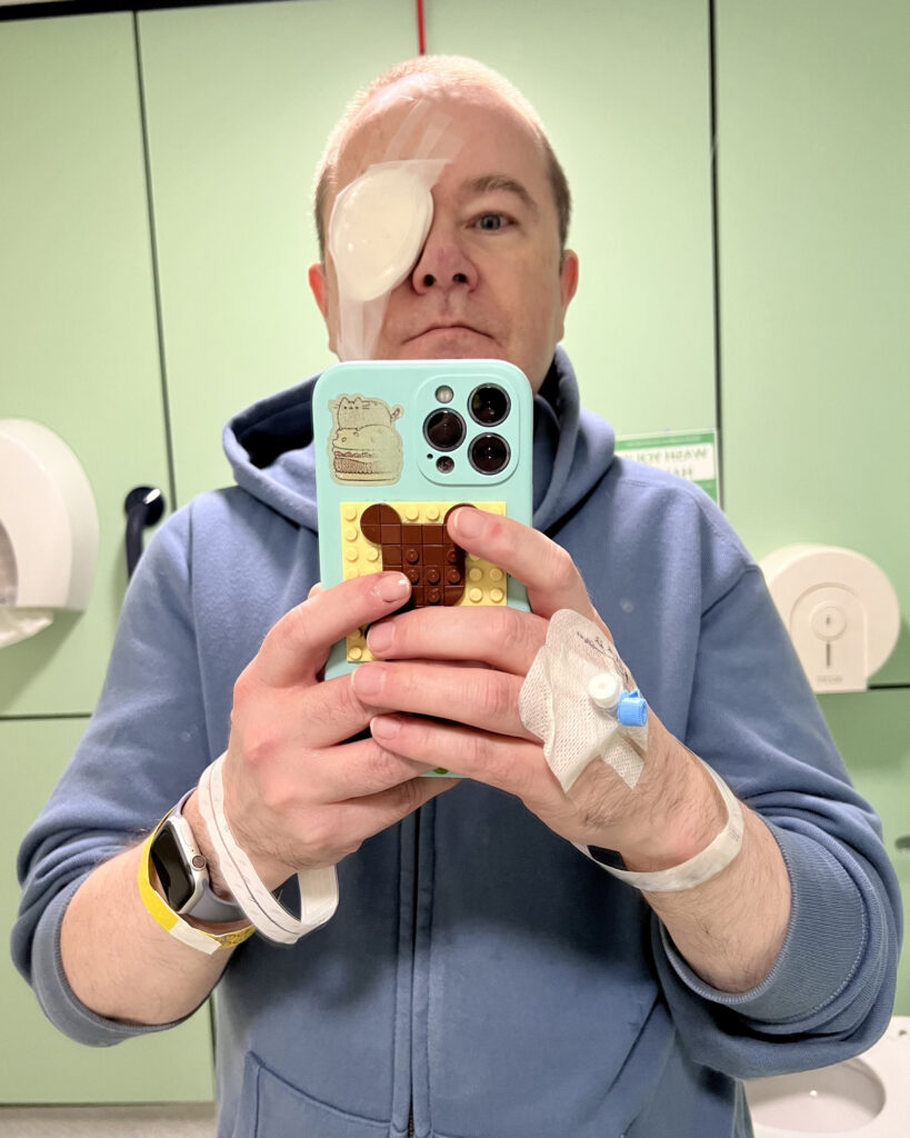 Stewart taking a selfie post-surgery, with a white dressing covering his left eye.