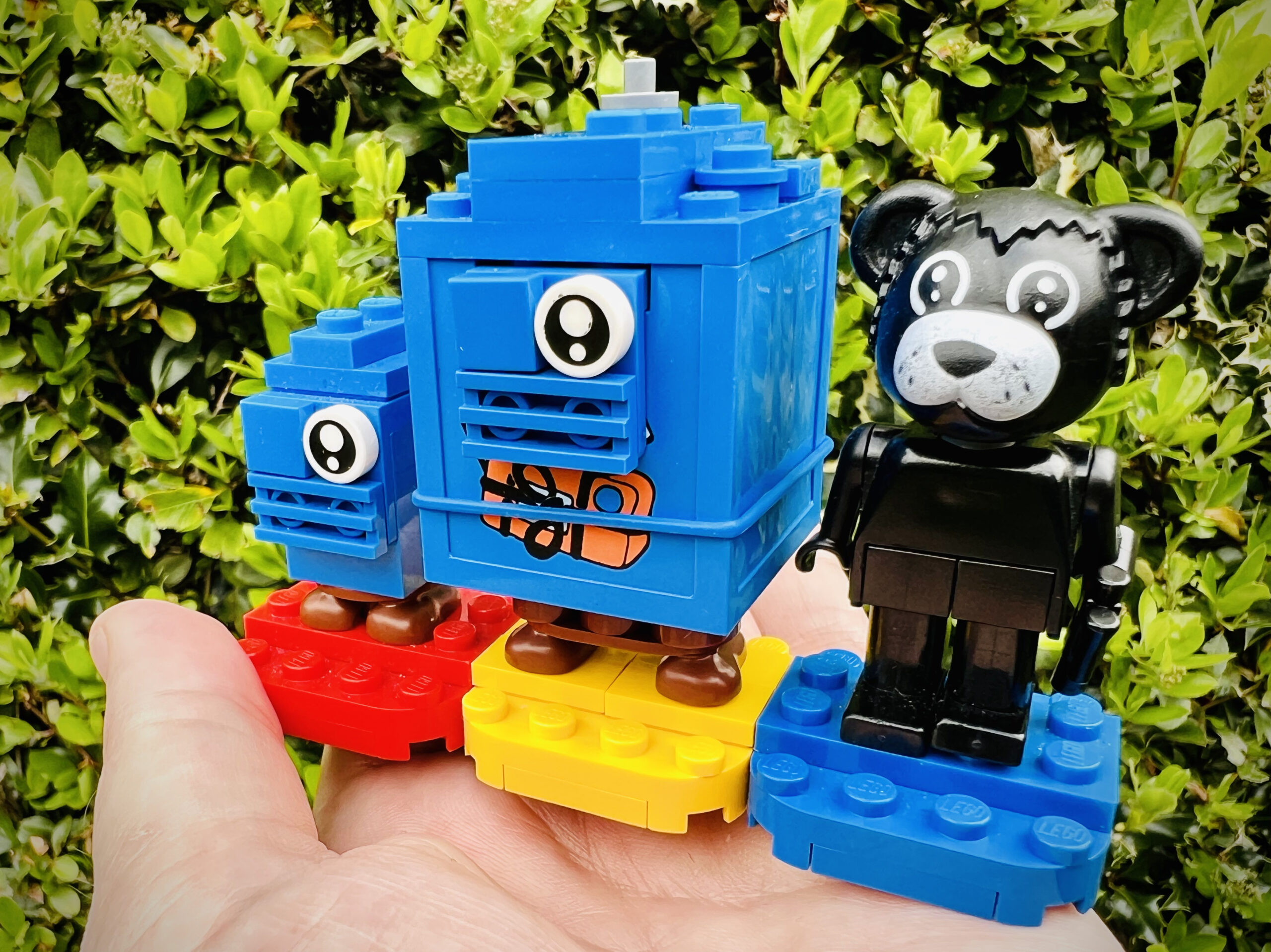 Two blue gonk droids and black bear.