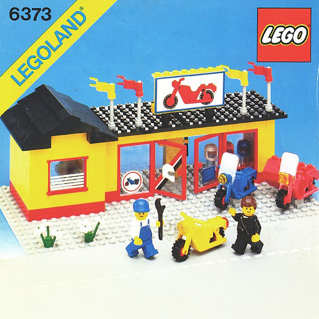 Legoland set 6373 - a yellow motorcycle shop with three bikes, a mechanic and rider.